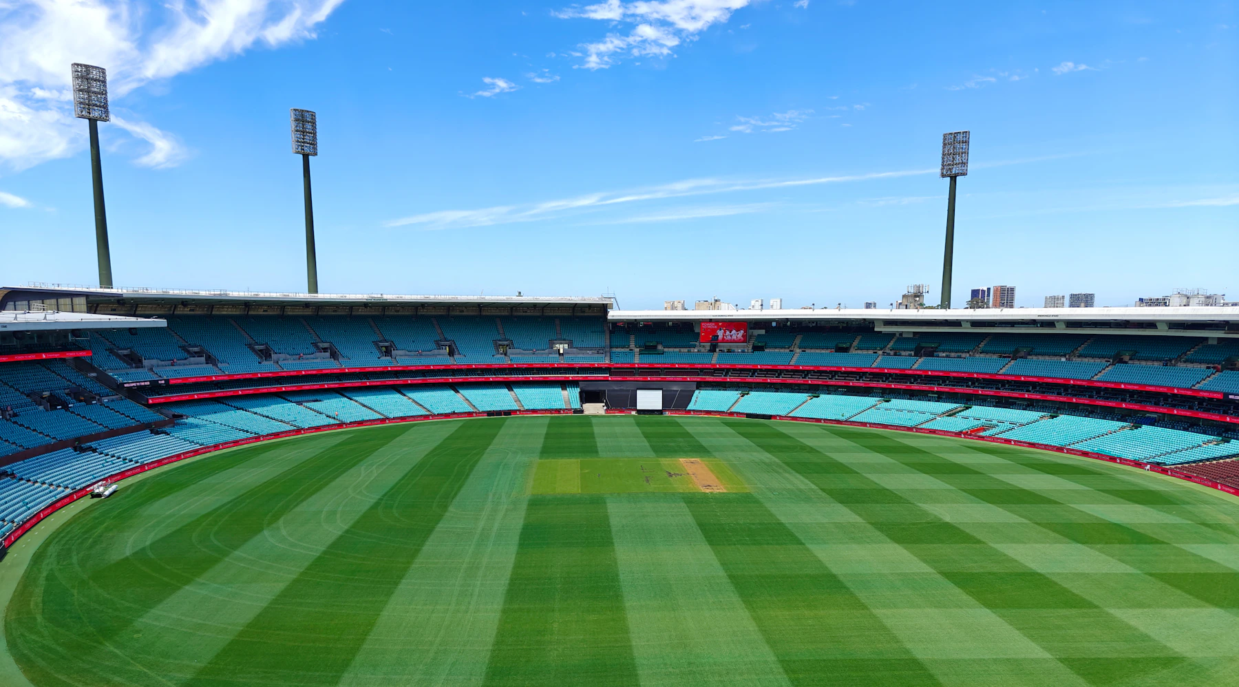Cricket ground and pavilion beneath an open sky